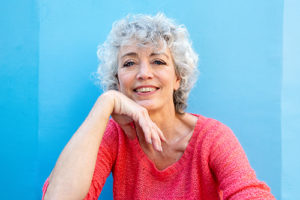 woman smiling with hand on chin